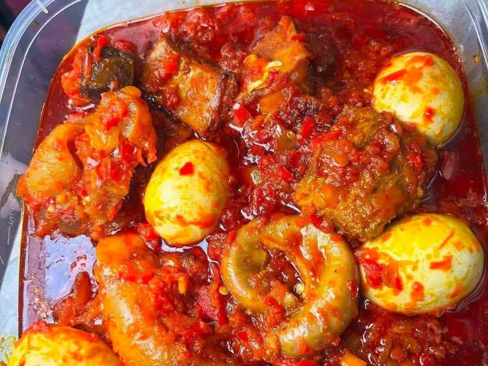 Pepper stew with boiled eggs and assorted meat in a takeaway tub