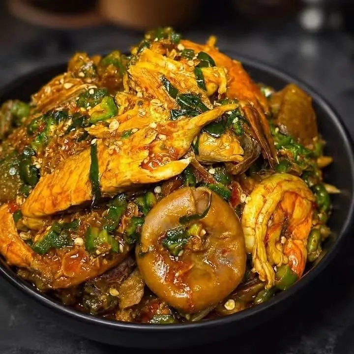 A bowl of okra soup with prawns and assorted meat